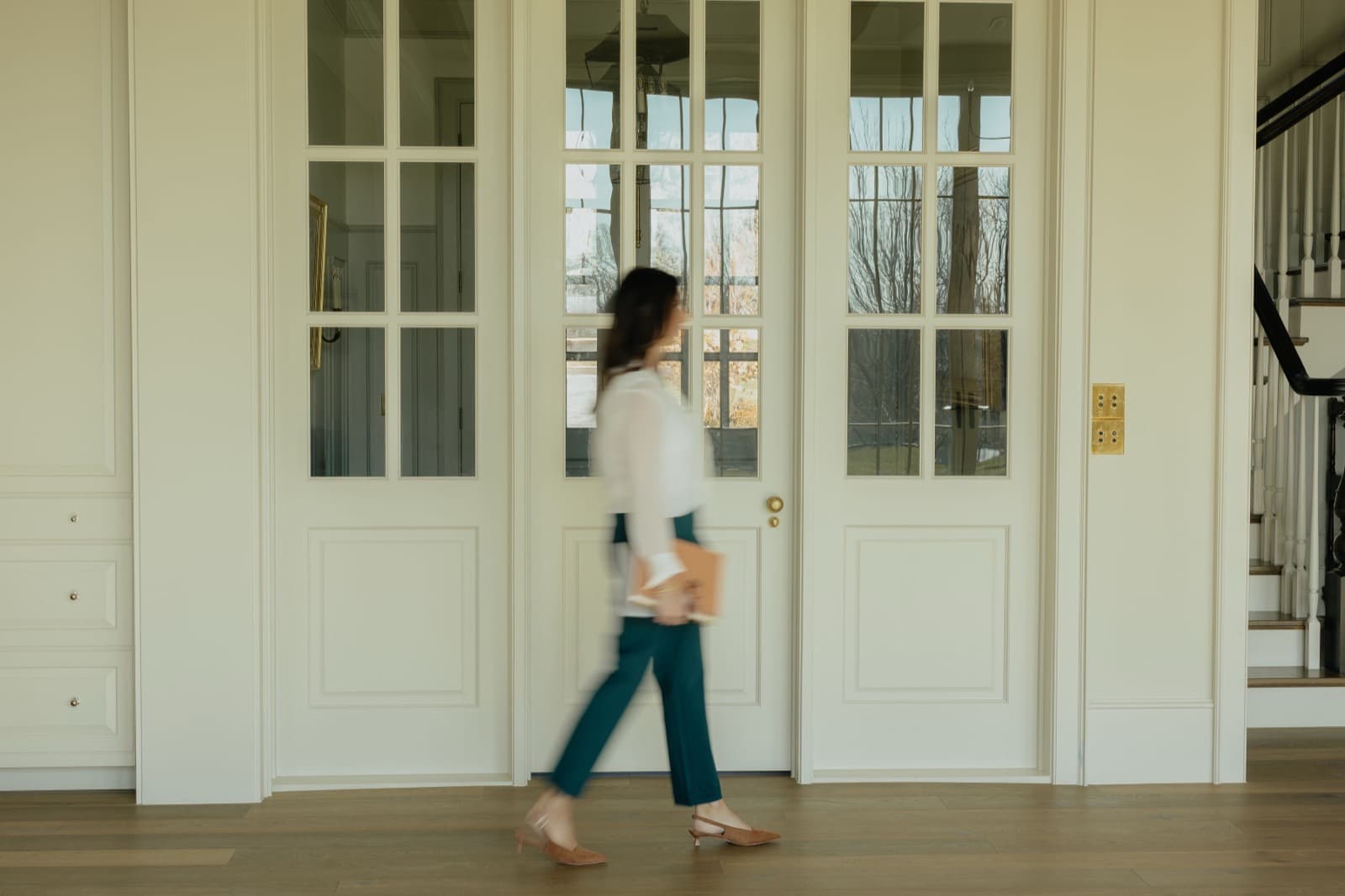 Nicki Christensen walking through a luxury home — always in motion for her clients